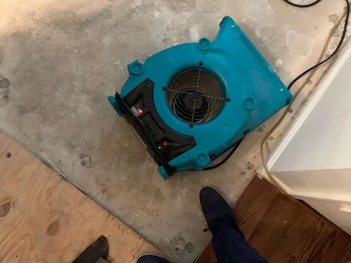 Air mover drying subfloor during Leak Detection & Repair in Guthrie